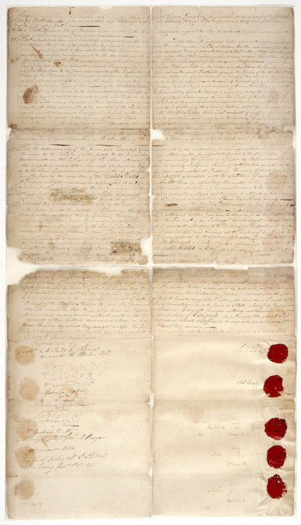 The above image depicts the Treaty of the Delaware from 1778, a large piece of paper that is divided between treaty text and signatures. The document is faded yellow-beige in color and appears to have been folded at four points as there are creases and wear. In the bottom-right hand corner, there are five red wax seals that are tied to some of the individuals who signed this treaty.